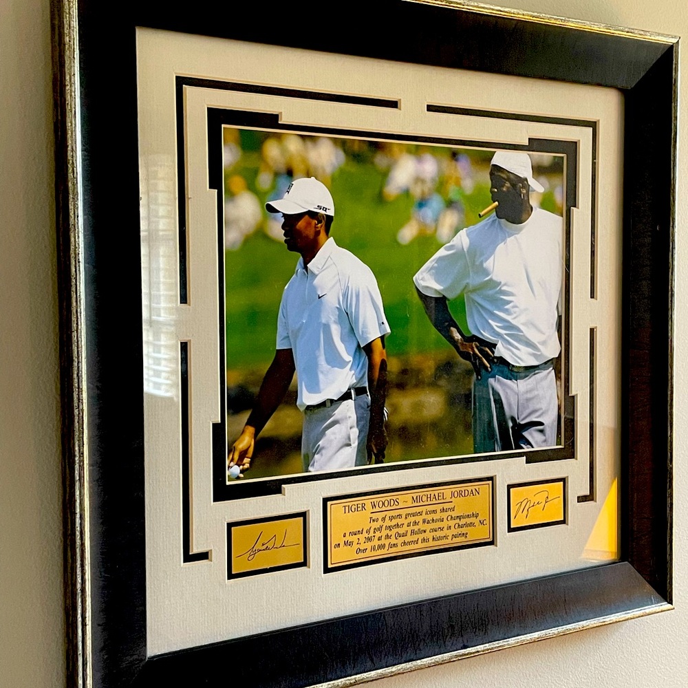 Framed photo of Tiger Woods and Michael Jordan playing golf
